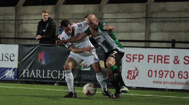 Geoff Kellaway: Battling with a Rhyl player to win the ball back for Aberystwth