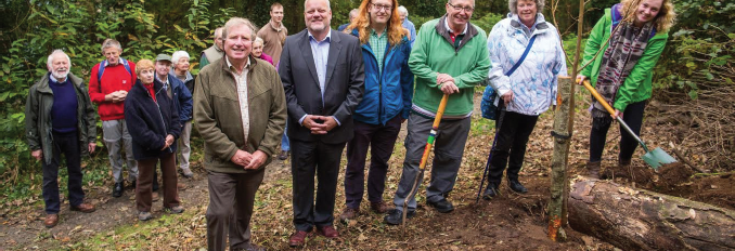 (L-R): Len Kersley, of the Parc Natur Penglais Support Group; Jim Wallace, representing Aberystwyth University; local councillor Mark Strong; with Oliver, Sue and Lizzie Tyson completing planting of the tree