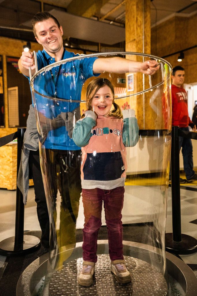 Children trying out one of Xplore!'s new additions to the centre, the Soap Bubble Ring