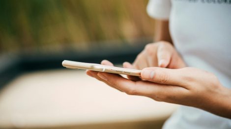 Person Standing While Using iPhone.